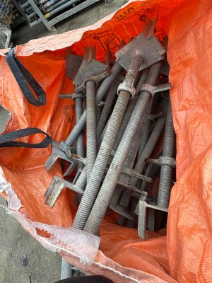 a bag full of bolts and wrenches sitting on the ground