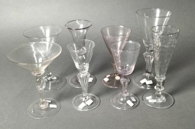six wine glasses sitting next to each other on a table