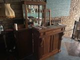 a desk with a mirror and a lamp in a room