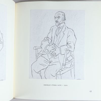an open book with a drawing of a man sitting in a chair