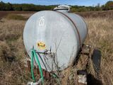 a tank that is sitting in the middle of a field