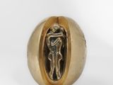 a close up of a gold ring with a statue inside of it