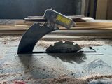 someone is using a circular saw to cut a piece of wood