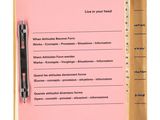 an image of a pink notepad with a pen on top of it