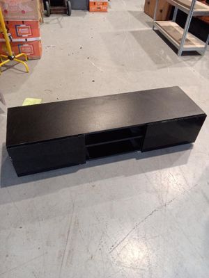 a black entertainment center in the middle of a warehouse