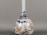 an image of a white vase with a blue and orange design on it