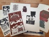 many different types of posters on a wooden table
