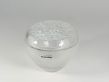 a glass container with a lid on a white surface