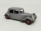 a gray toy car with red wheels on a white surface