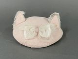 a small pink cat with a bow on it ' s head