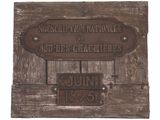 a plaque on the wall of a building with a name on it