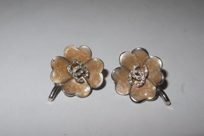 pair of flower shaped earrings with crystal stones on top of them