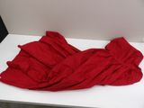 a red blanket on a white table in a room