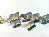 five figurines of animals that are standing in a row
