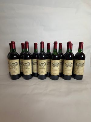 six bottles of wine are lined up on a table