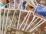 a white plate with many different bank notes on it