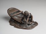 a bronze statue of a man in a boat