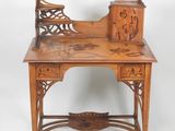 a small wooden desk with a carved top
