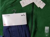 a green jacket and a pair of blue pants on a table