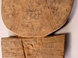 two pieces of wood with designs on them on a white surface