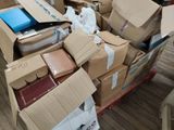 a pile of boxes on a deck with a laptop in it