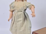a small doll that is standing next to a box