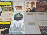 a lot of records on a table with a man playing a trumpet