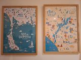 two maps hanging on the wall of a room