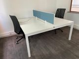 a desk with a chair and a computer on it