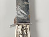 a knife that is on top of a piece of wood