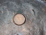 a close up of a metal object with a coin in it
