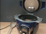 a close up of an electric pressure cooker on a table