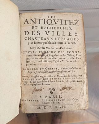 an old book on display in a glass case