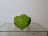 a green apple sitting on top of a glass table