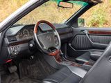 the interior of a car with the door open and the driver ' s seat up