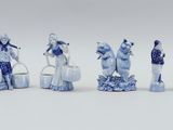 six blue and white figurines of people playing musical instruments
