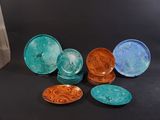 many different colored plates sitting on a black table
