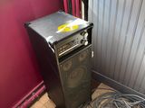 an image of a room with a refrigerator and a trash can