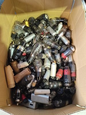 a cardboard box filled with assorted bottles of alcohol