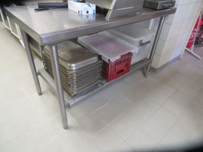 a large stainless steel table with a laptop on top of it