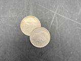 two coins sitting on top of each other on a table
