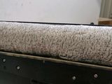 a close up of a bed with a pillow on top of it