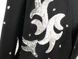 a close up of a black jacket with silver sequins