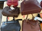 a lot of purses that are on a table