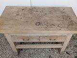 a small wooden table with writing on it