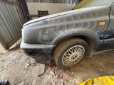 a car that has been vandalized with graffiti on the side of it