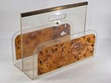 a clear plastic magazine holder with a piece of bread in it