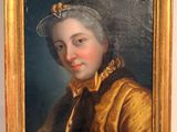 portrait of a woman in a gold coat and a black hat
