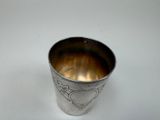 a silver cup that is sitting on a table