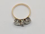 a close up of a gold ring with three skulls on it